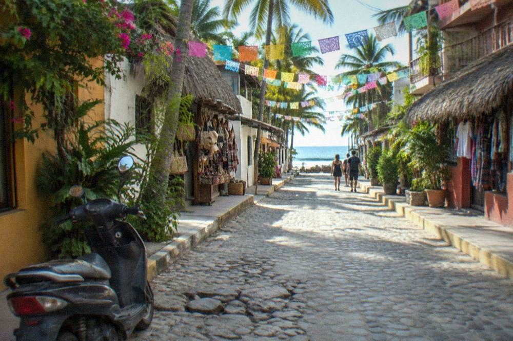 A colorful street in Sayulita with banners strung above the road