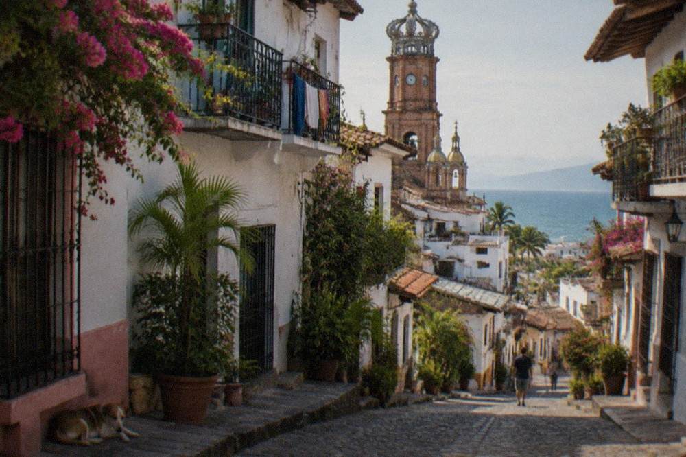 Cobblestone street in old town Puerto Vallarta with colorful buildings and the church tower visible