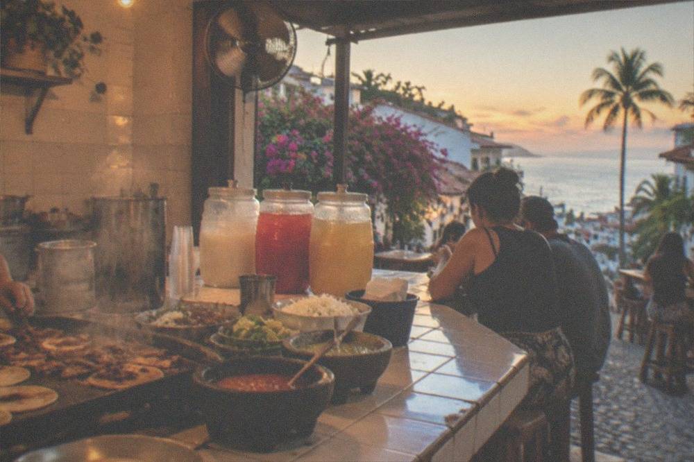 Street tacos and drinks arranged on a counter in a Puerto Vallarta eatery