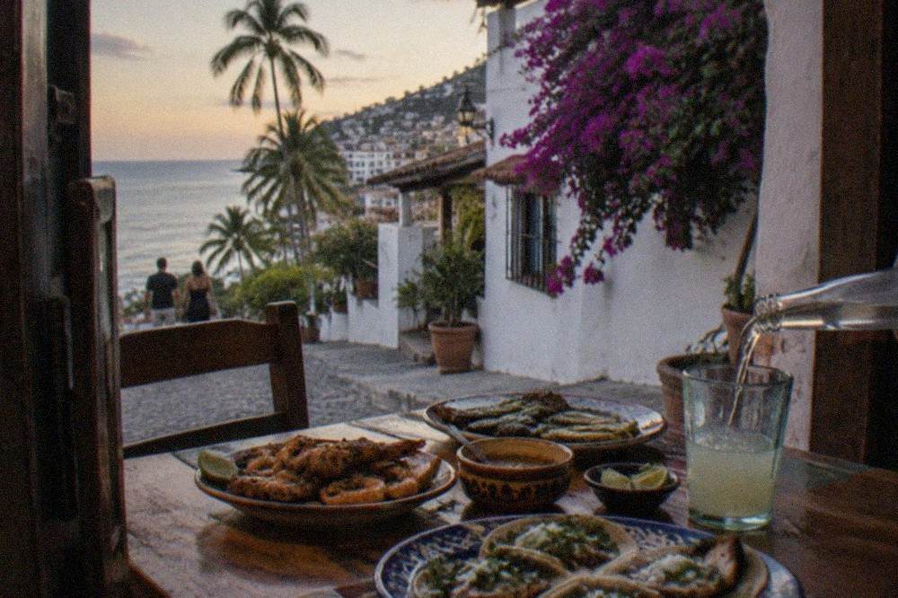 Colorful plates of tacos and grilled street food on an outdoor restaurant table in Puerto Vallarta