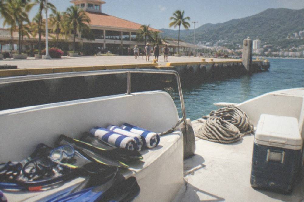 Snorkeling gear and towels laid out on a boat deck