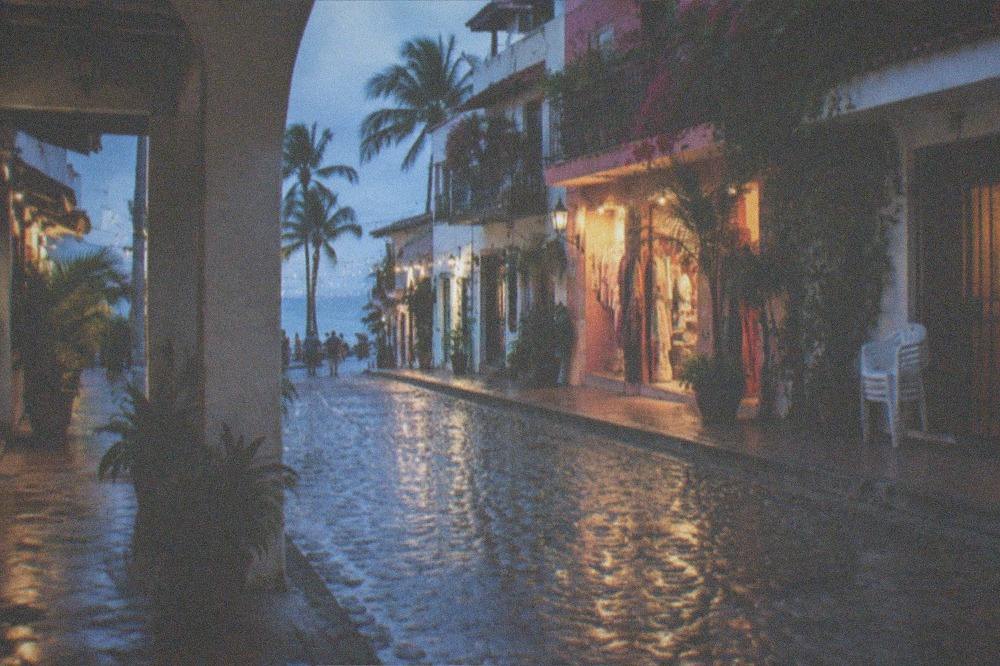 A colorful evening street in the Zona Romantica with lit storefronts
