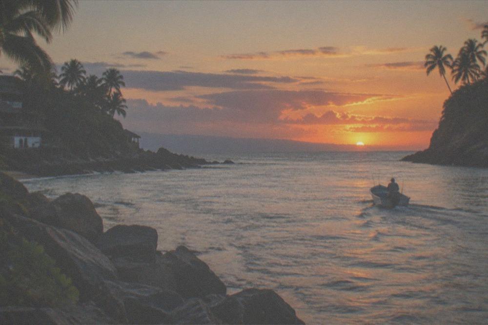 Ocean horizon at sunset with calm water and distant clouds over Banderas Bay
