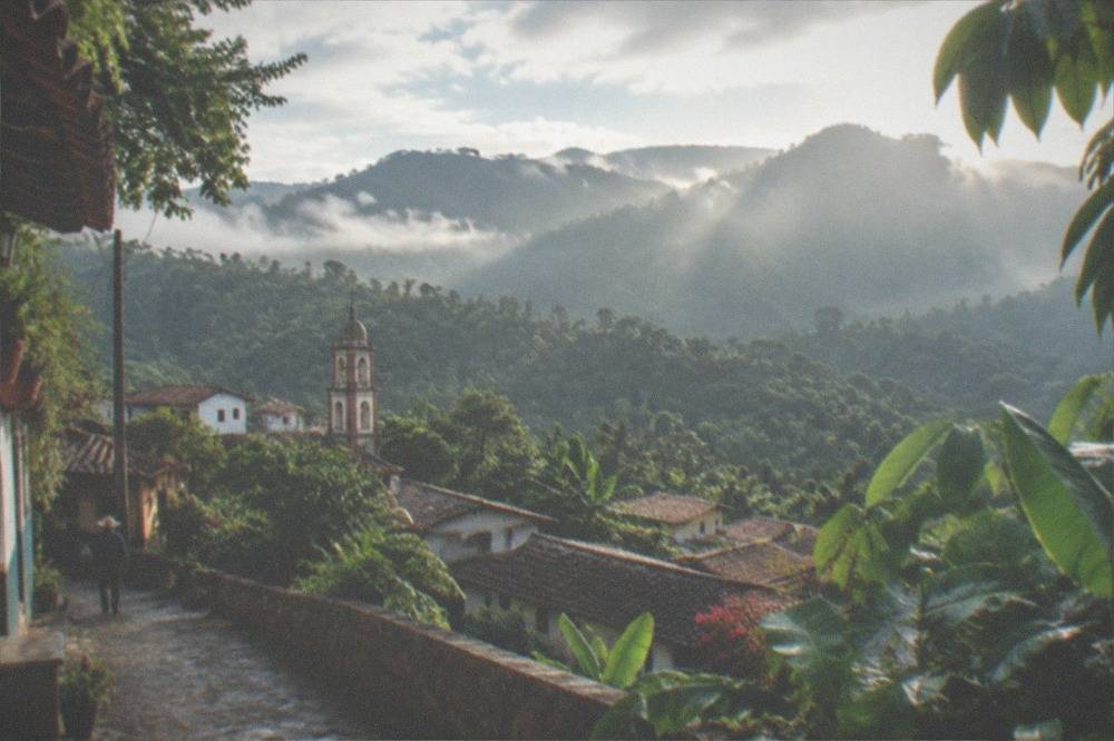 Sunlight breaking through mist over jungle covered mountains near Puerto Vallarta